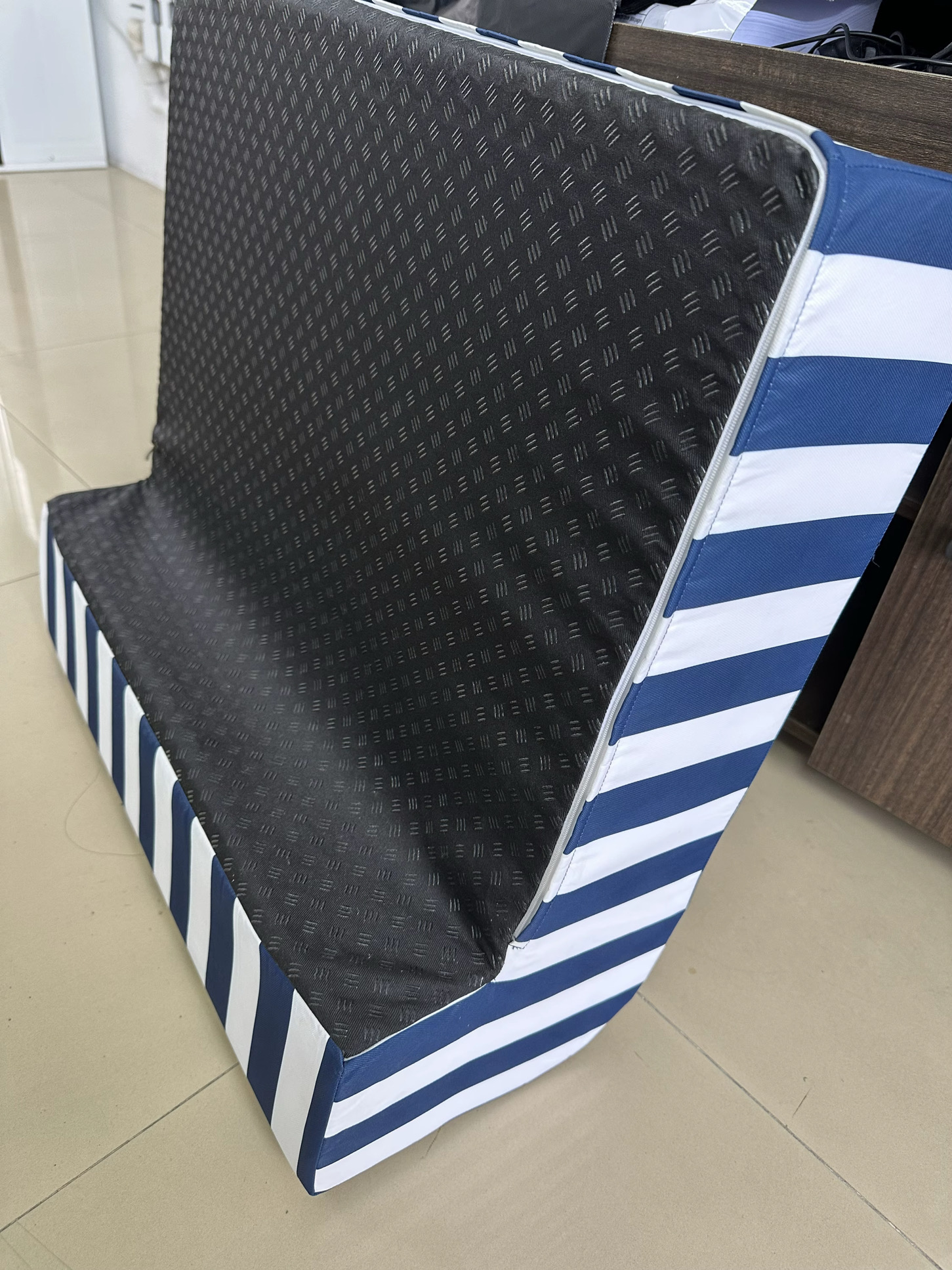 Underside of the Aegean Navy Akti cushion showing the textured non-slip base and metal zip