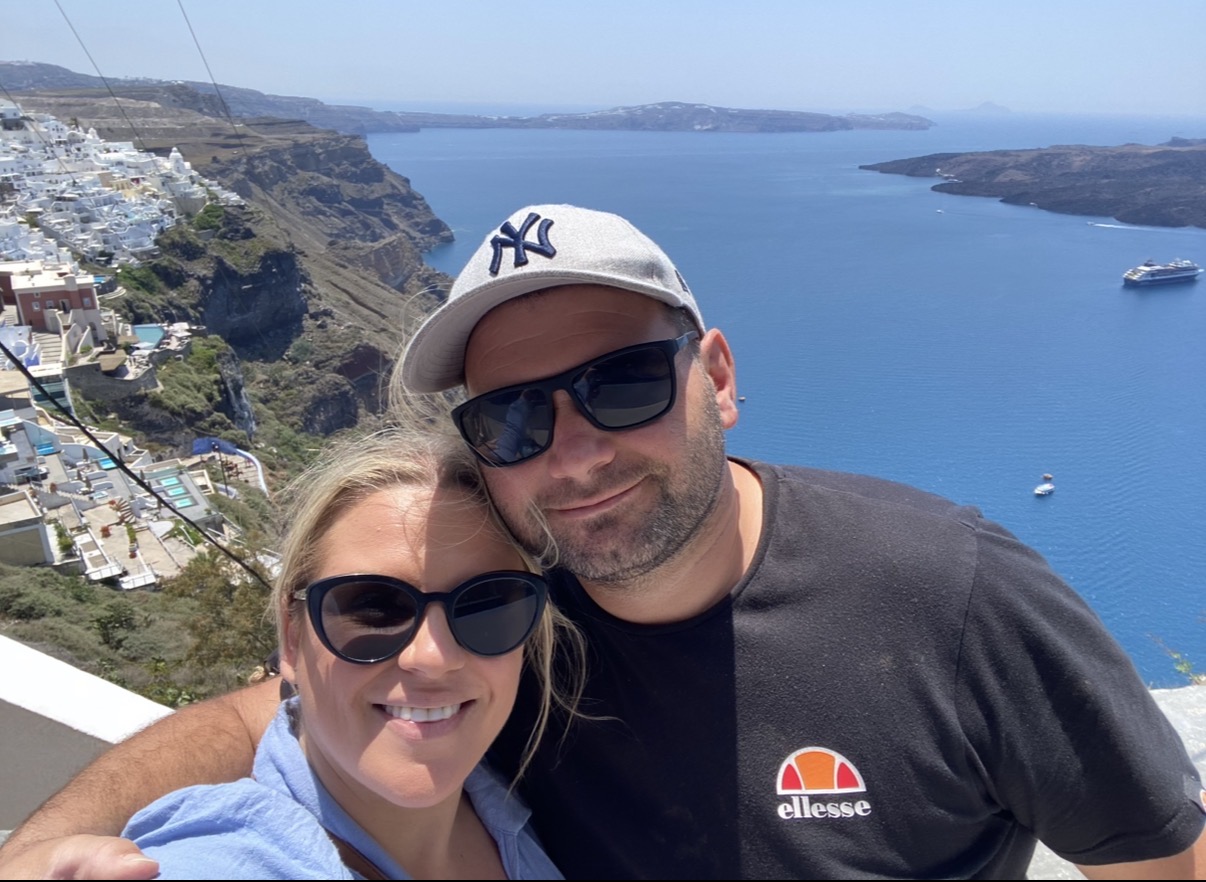 The two of us above the caldera in Santorini with the deep blue sea behind us