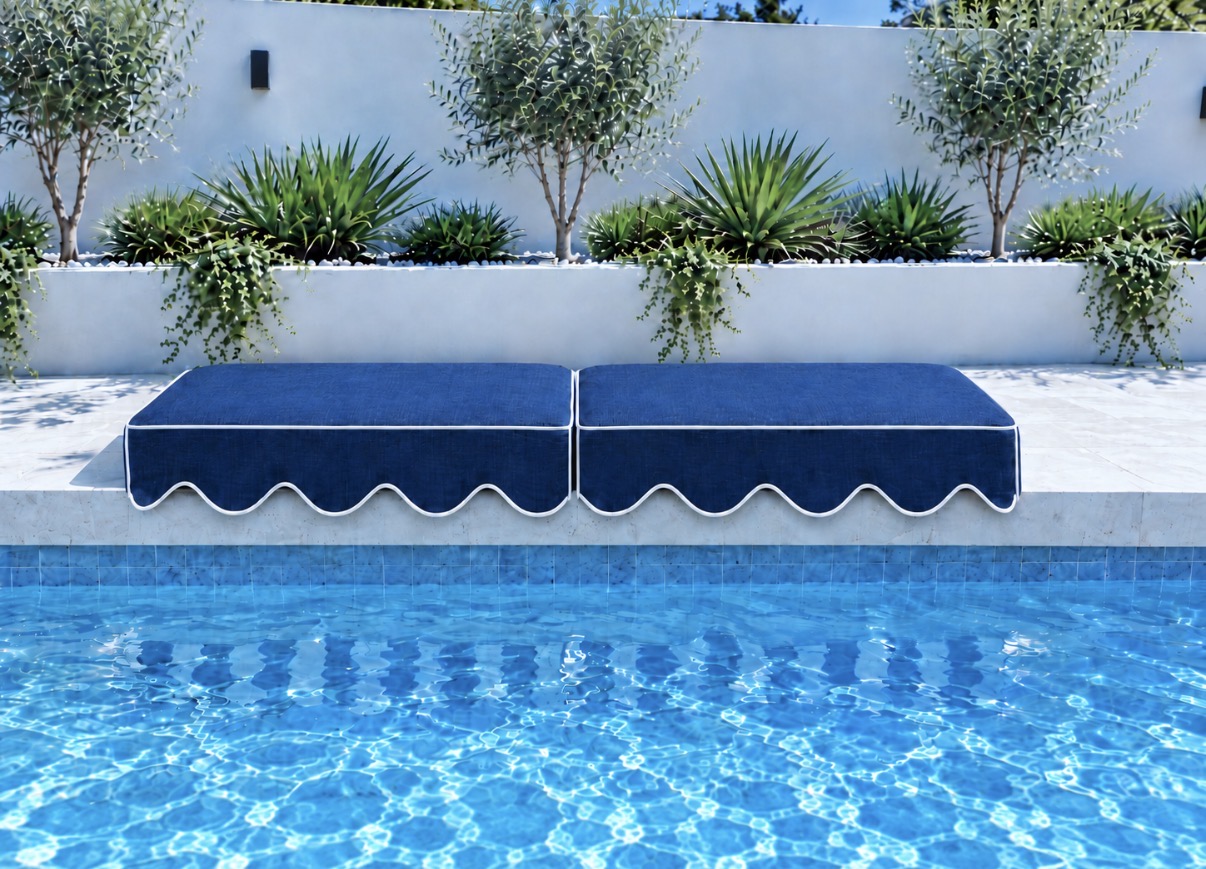 Two Riviera Navy Blue Akti cushions with scalloped lips and contrasting piping on pale pool coping