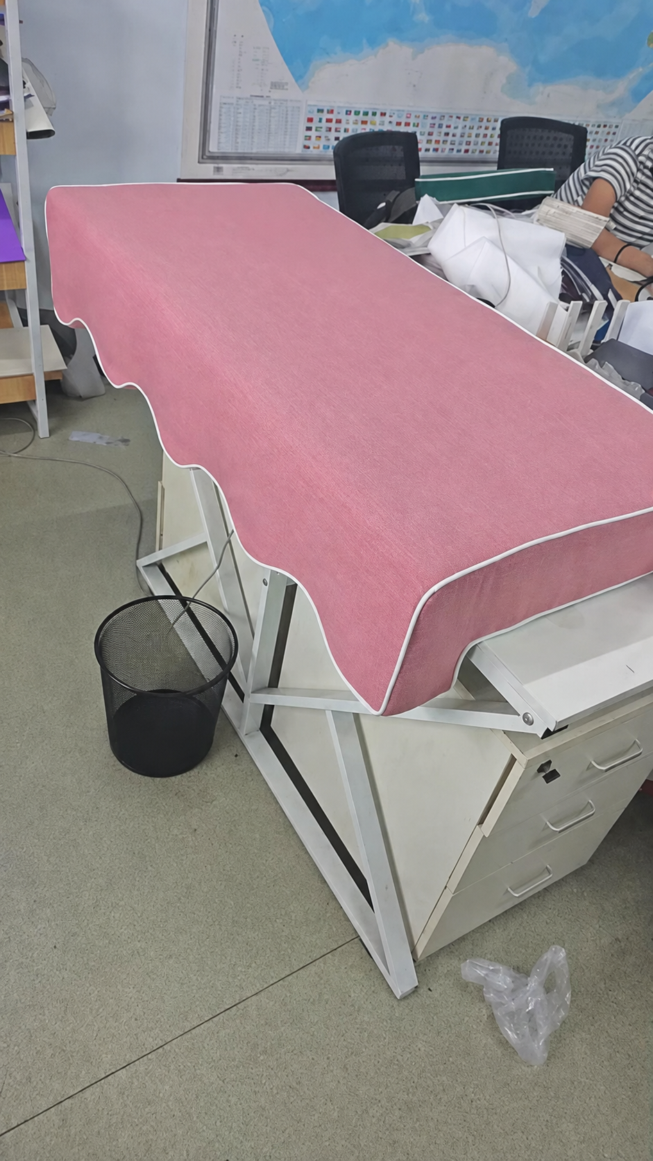 A pink Akti Riviera cushion with its scalloped lip and white piping, shown as a custom order colour